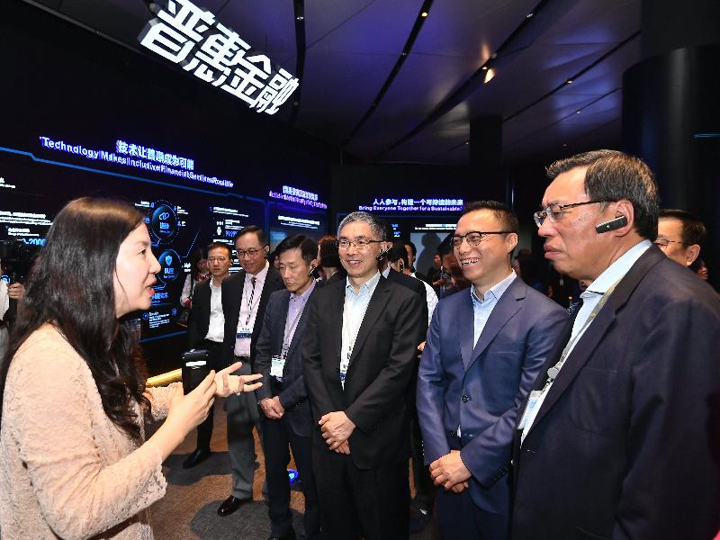 The Secretary for Constitutional and Mainland Affairs, Mr Patrick Nip; the Secretary for Innovation and Technology, Mr Nicholas W Yang; the Secretary for Financial Services and the Treasury, Mr James Lau; and Legislative Council members visited the Alibaba Group in Hangzhou this morning (April 24) during the Legislative Council joint-panel duty visit to the major cities in the Yangtze River Delta Region. Photo shows Mr Yang (second left), Mr Lau (third right) and others receiving a briefing while touring the Alibaba exhibition hall.