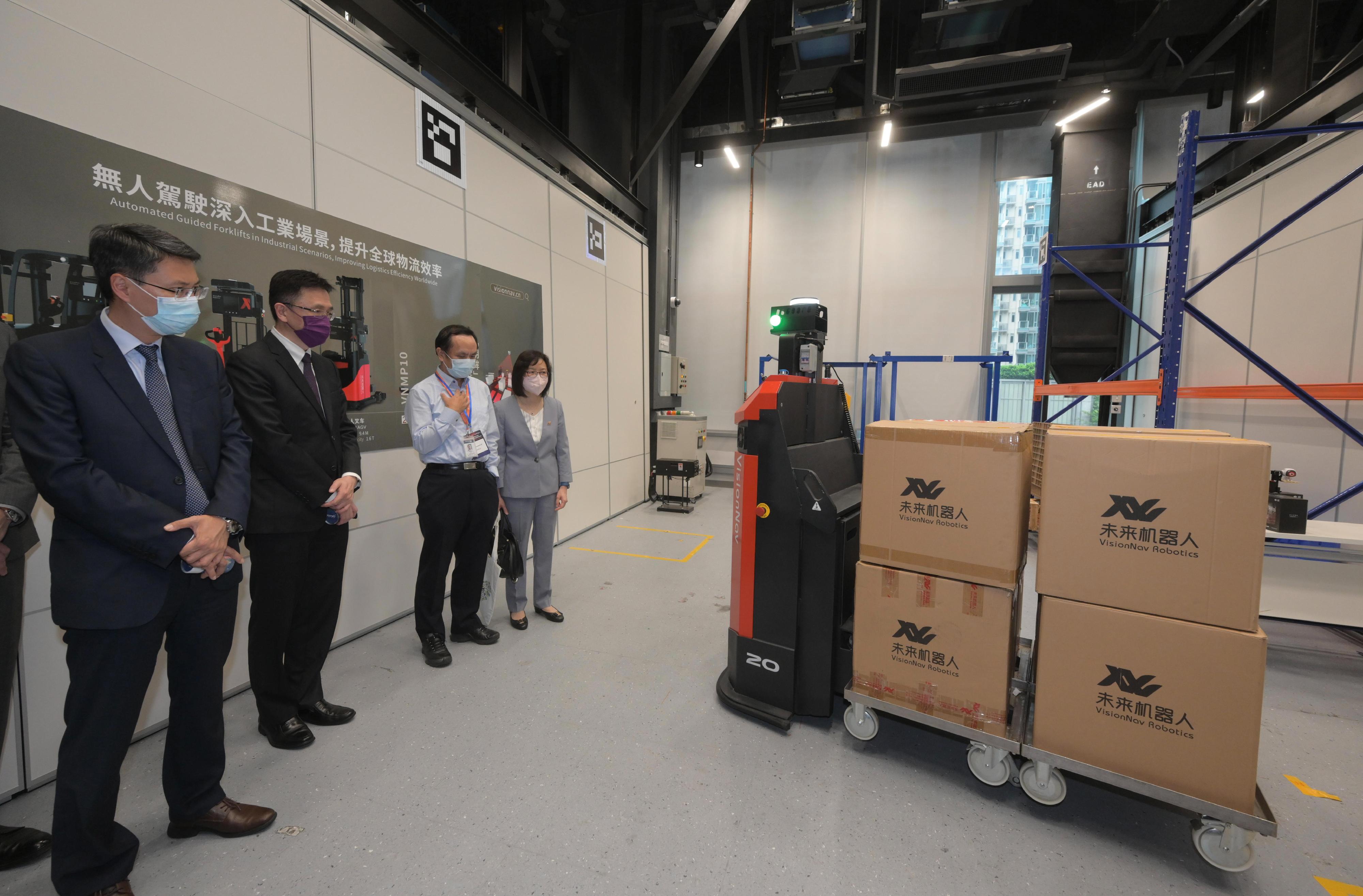 The Secretary for Innovation, Technology and Industry, Professor Sun Dong (second left), visits a partner company of the Hong Kong Science and Technology Parks Corporation at the Hong Kong Science Park today (August 9) and receives a briefing on unmanned industrial vehicles. Also present are the Permanent Secretary for Innovation, Technology and Industry, Mr Eddie Mak (first left), and the Commissioner for Innovation and Technology, Ms Rebecca Pun (first right).