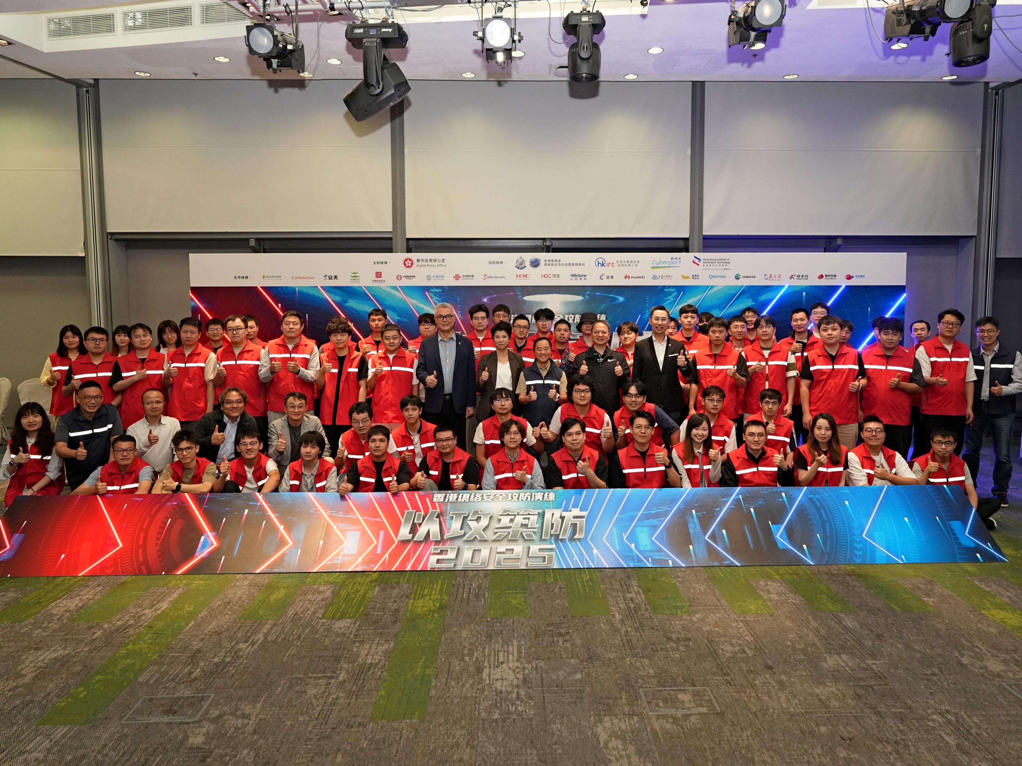 「香港網絡安全攻防演練—以攻築防2025」昨晚（十月十二日）圓滿結束。圖示數字政策專員黃志光（第三排右九）與協辦單位代表、參賽隊伍和工作人員合照。