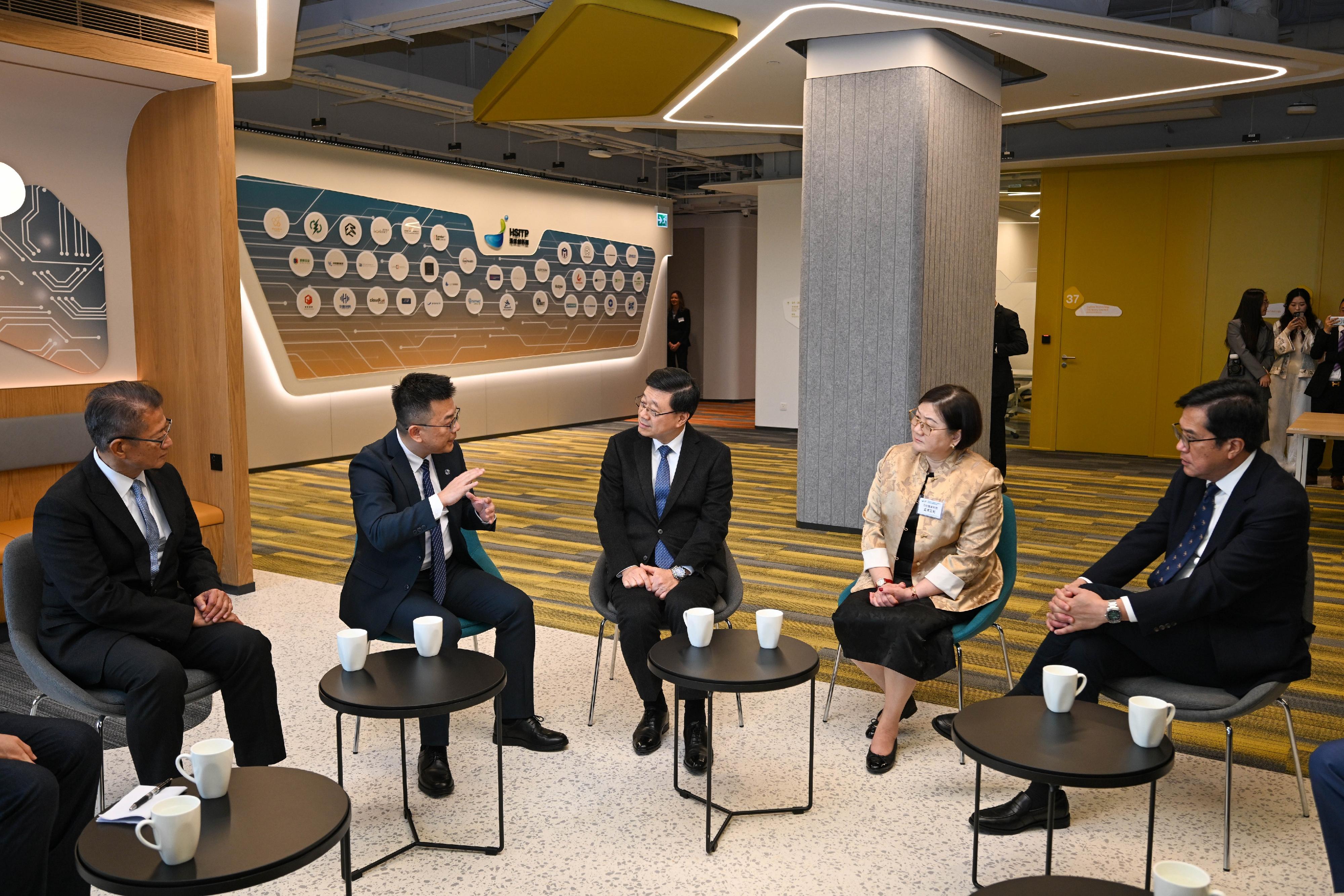 The Chief Executive, Mr John Lee, attended the Hong Kong-Shenzhen Innovation and Technology Park opening ceremony today (December 22). Photo shows Mr Lee (centre) exchanging views with representatives of the enterprises. Looking on are the Financial Secretary, Mr Paul Chan (first left), and the Deputy Financial Secretary, Mr Michael Wong (first right).
