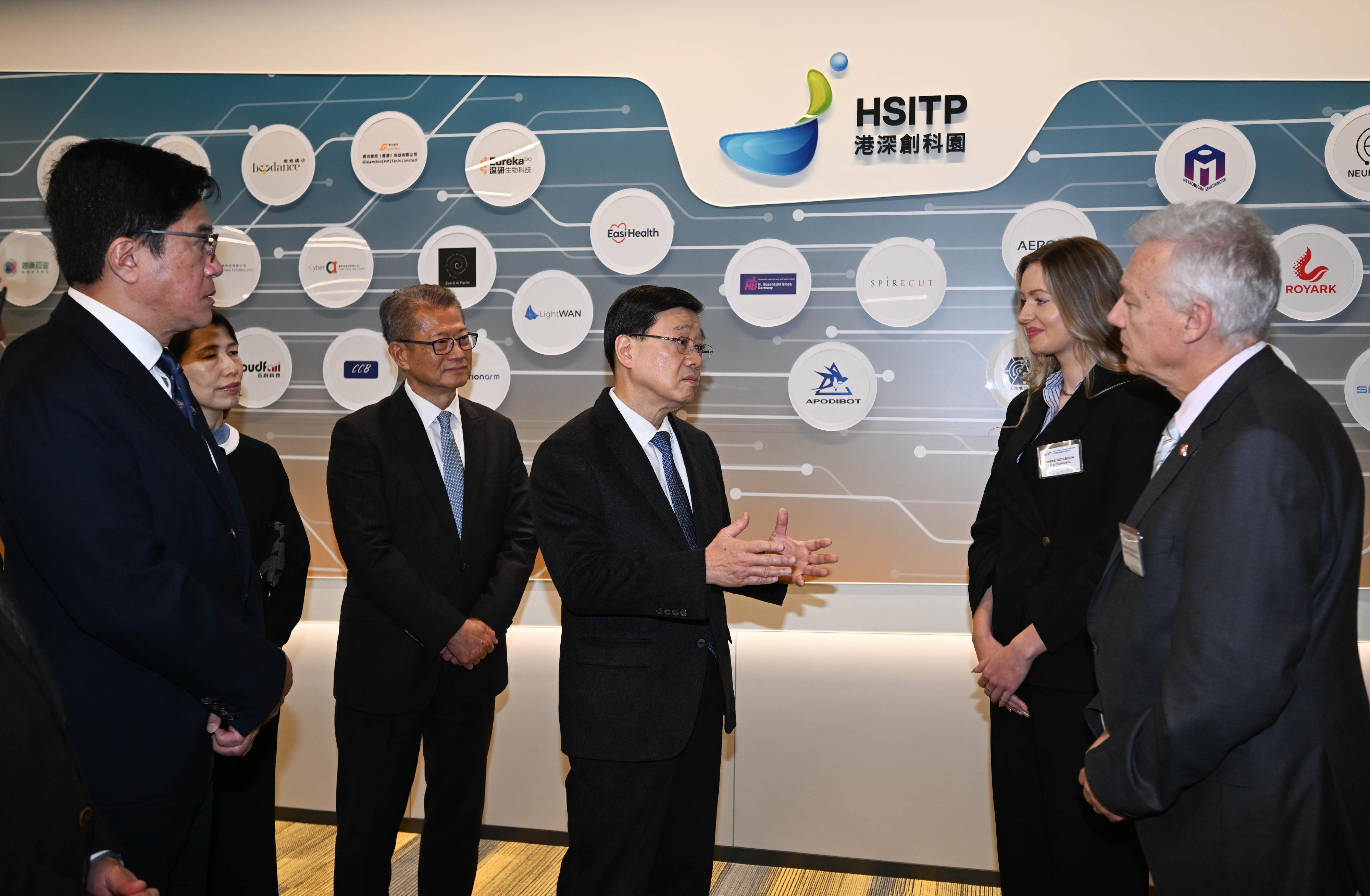 The Chief Executive, Mr John Lee, attended the Hong Kong-Shenzhen Innovation and Technology Park opening ceremony today (December 22). Photo shows Mr Lee (third right) exchanging views with representatives of the enterprises. Looking on are the Financial Secretary, Mr Paul Chan (third left), and the Deputy Financial Secretary, Mr Michael Wong (first left).